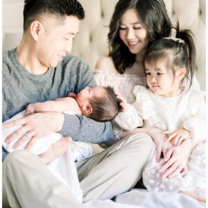 Young parents, a little girl, and a newborn baby